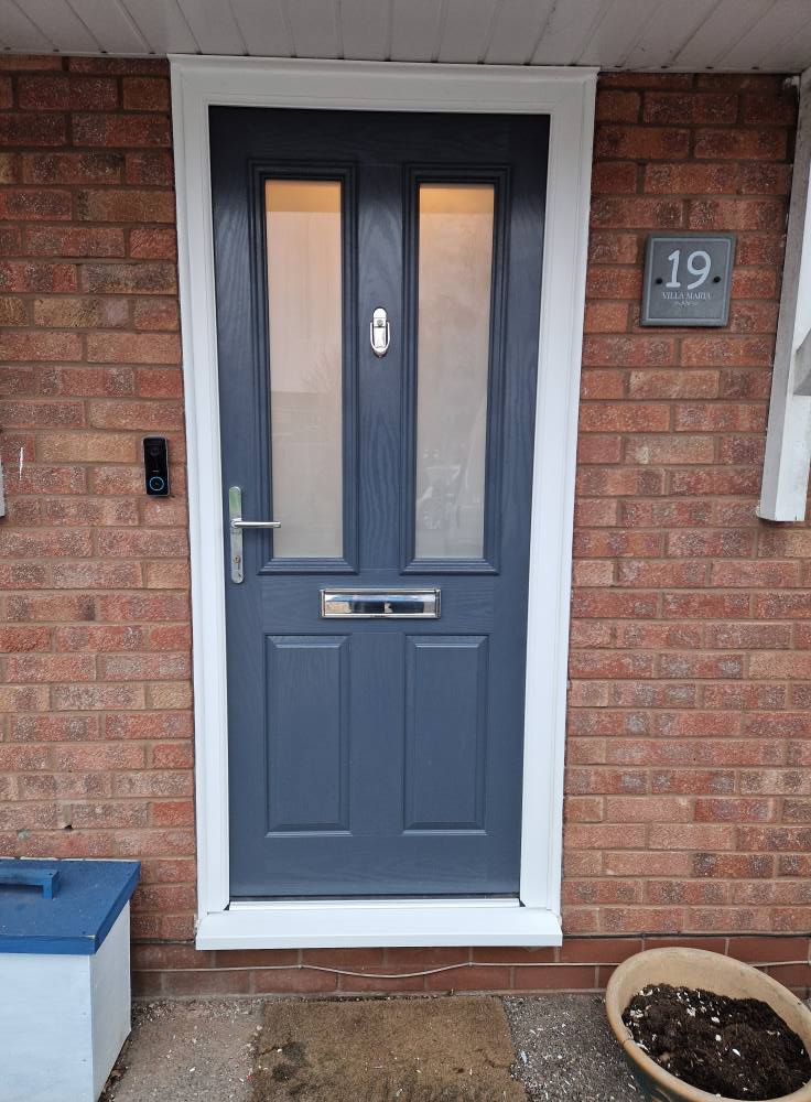 Blue UPVC composite front door with decorative glass panels installed in Cannock